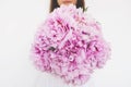 Woman holding beautiful bunch of fresh pink peony flowers in full bloom Royalty Free Stock Photo