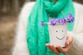 Woman holding beautiful snowdrops in a paper cup. first spring flowers in a forest. Wild flowers. spring concept Royalty Free Stock Photo