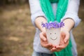 Woman holding beautiful snowdrops in a paper cup. first spring flowers in a forest. Wild flowers. spring concept Royalty Free Stock Photo