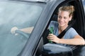 woman holding beer bottles and consuming alcohol while driving
