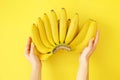 Beautiful minimlistic flat lay composition with ripe fresh organic bananas hand in warm yellow colors. Top view copy space, close Royalty Free Stock Photo