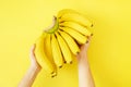 Beautiful minimlistic flat lay composition with ripe fresh organic bananas hand in warm yellow colors. Top view copy space, close Royalty Free Stock Photo