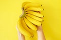 Beautiful minimlistic flat lay composition with ripe fresh organic bananas hand in warm yellow colors. Top view copy space, close Royalty Free Stock Photo