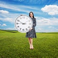 Woman holding big clock and looking Royalty Free Stock Photo