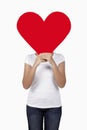 Woman holding a big cut out red heart over her face. Conceptual image Royalty Free Stock Photo