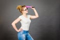 Woman holding big oversized pencil thinking about something Royalty Free Stock Photo