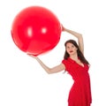 Woman holding big red balloon above her head