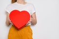 Woman holding a big red box in shape of a heart. Trendy video banner for Valentines Day, International Womens Day or Royalty Free Stock Photo