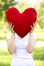 Woman holding big red heart before her face Royalty Free Stock Photo