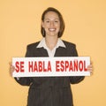 Woman holding bilingual sign Royalty Free Stock Photo