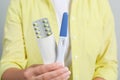 Woman holding birth control pills pregnancy test on grey background, closeup Royalty Free Stock Photo