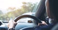 Woman holding on black steering wheel while driving a car Royalty Free Stock Photo