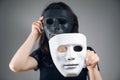 woman holding black and white plastic mask Royalty Free Stock Photo