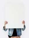 Woman holding blank banner cover face studio portrait Royalty Free Stock Photo