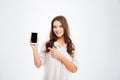 Woman holding blank screen mobile phone and pointing finger