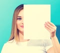 Woman holding a blank sheet of paper Royalty Free Stock Photo