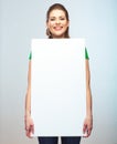 Woman holding blank white board isolated studio portrait.