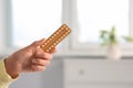 Woman holding blister of oral contraception pills in bedroom, closeup. Space for text Royalty Free Stock Photo