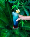 Woman holding blue colored cocktail Royalty Free Stock Photo