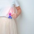 Woman holding Blue ribbon with having Abdomen pain. March Colorectal Cancer Awareness month, Colonic disease, Large Intestine,