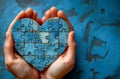 Woman holding the blue shape of heart made of puzzle pieces. World autism awareness. Royalty Free Stock Photo