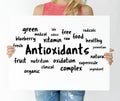 Woman holding a board with Antioxidants concept