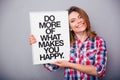 Woman holding board with motivational phrase