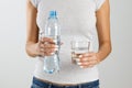 Woman holding a bottle and a glass of water in her hands Royalty Free Stock Photo