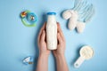 Woman holding bottle of milk with powder and toys on color background Royalty Free Stock Photo