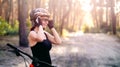 Woman holding bottle next to bike Royalty Free Stock Photo