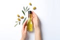Woman holding bottle with oil and ripe olives Royalty Free Stock Photo