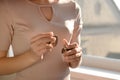 Woman holding bottle of perfume  near window Royalty Free Stock Photo