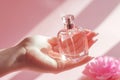 Woman holding bottle perfume smell aroma advertising freshness design elegance fragrance pink liquid luxury exclusive Royalty Free Stock Photo