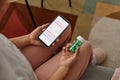 Woman Holding Bottle of Pills and Smartphone Royalty Free Stock Photo