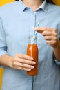 Woman holding bottle of tasty carrot juice Royalty Free Stock Photo