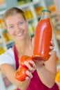 Woman holding bottle tomato juice