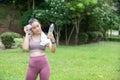 Woman holding a bottle of water to rest after exercising in the park Royalty Free Stock Photo