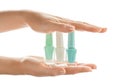 Woman holding bottles of colorful nail polishes on white background Royalty Free Stock Photo