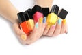 Woman holding bottles of nail polish on white background Royalty Free Stock Photo