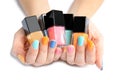 Woman holding bottles of nail polish on white, closeup Royalty Free Stock Photo