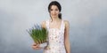 Woman Holding Bouquet of Flowers in Hands Indoors