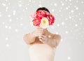 Woman holding bouquet of flowers over her face Royalty Free Stock Photo