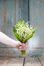 Woman holding bouquet of lily of the valley flowers Royalty Free Stock Photo