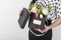 Woman holding bouquet of roses and tulips in box Royalty Free Stock Photo