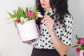 Woman holding bouquet of roses and tulips in box Royalty Free Stock Photo