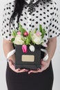Woman holding bouquet of roses and tulips in box Royalty Free Stock Photo