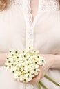 Woman holding bouquet of tiny white flowers (ornithogalum arabic Royalty Free Stock Photo