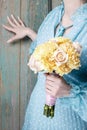 Woman holding bouquet of yellow carnation and pink roses Royalty Free Stock Photo