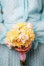 Woman holding bouquet of yellow carnation and pink roses Royalty Free Stock Photo