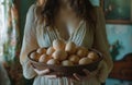 a woman holding a bowl filled with many eggs